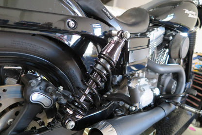 Close-up of a motorcycle's suspension system with visible branding.
