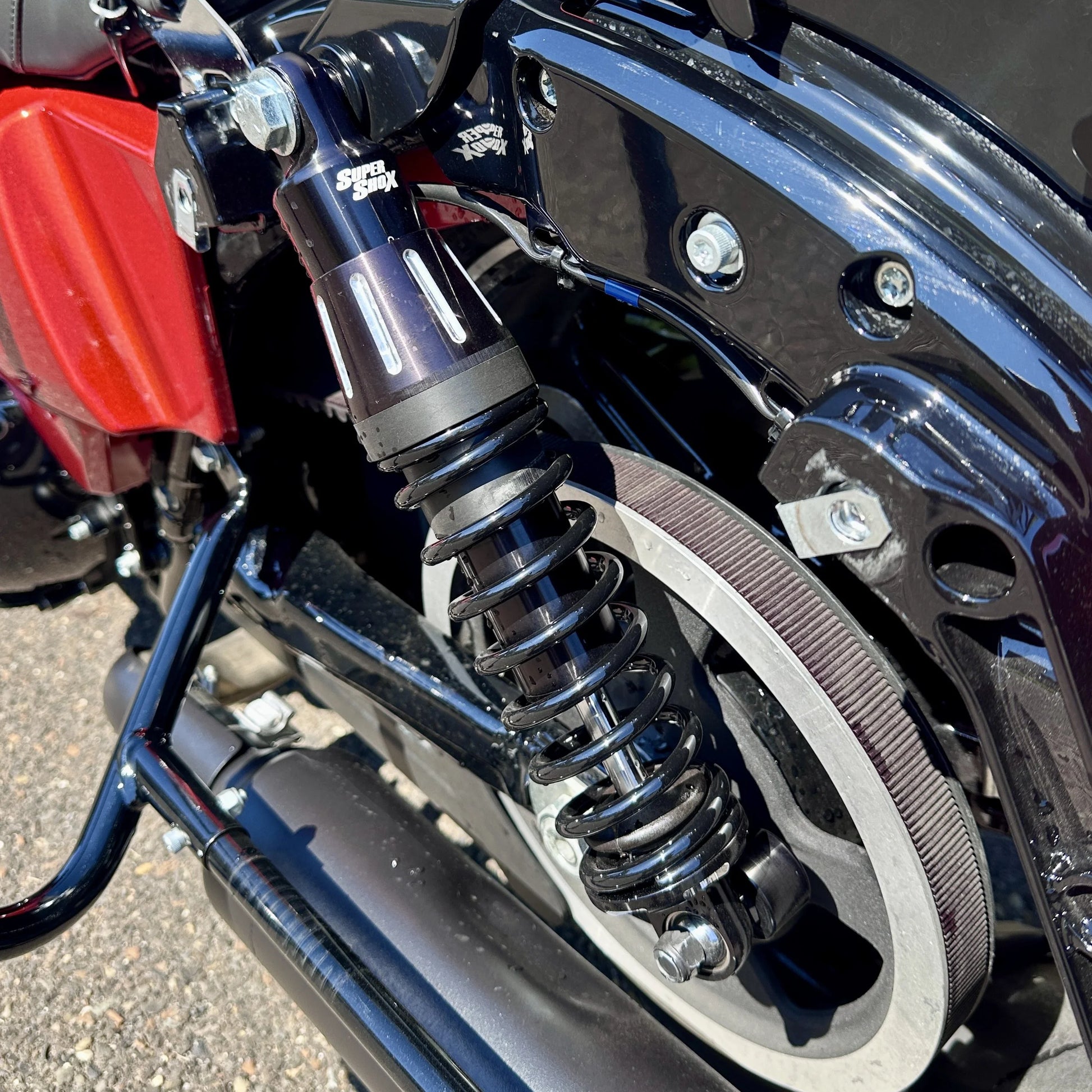 Close-up of a motorcycle suspension system with visible branding.