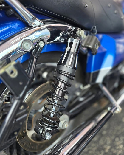 Black Super Shox rear shock installed on a blue Harley-Davidson