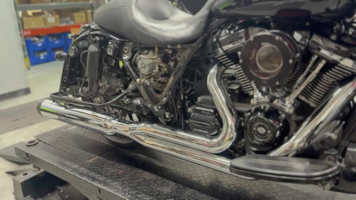 Close-up of chrome TAB Performance Redline 2-1 header pipes installed on a black 2019 Harley-Davidson Street Glide, right side