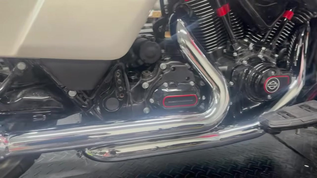 Close-up of chrome TAB Performance Redline 2-2 stepped headers installed on a white Harley-Davidson CVO Road Glide ST, right side